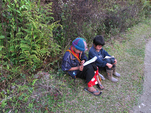 Students reading on the road while going back home