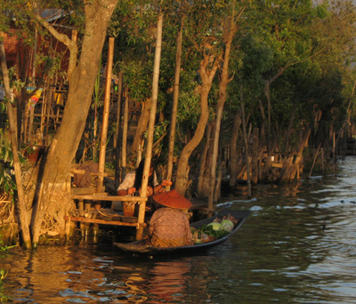 Buying vegetable, fruits and flowers from the boat