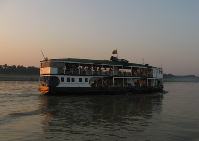 A double decker boat cruising down the Ayeyarwaddy river
