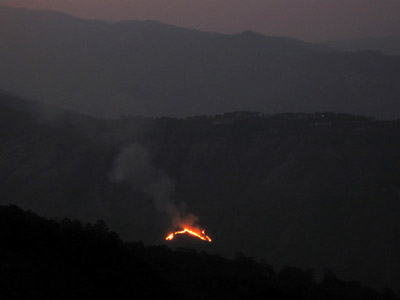 Forest fire on the mountain slope seen from E-Sakan village